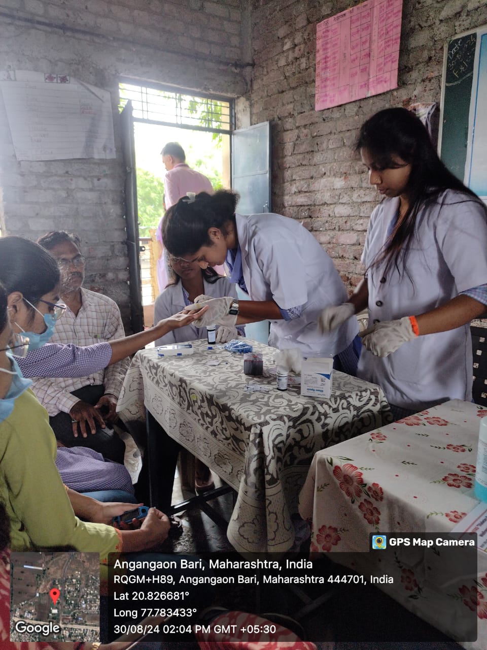 Students & medical staff performing the blood sugar test