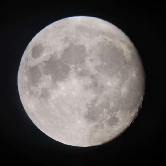 Moon photograph captured through telescope using mobile camera