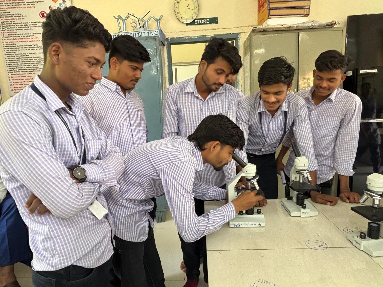 Students observing the slides under microscope.