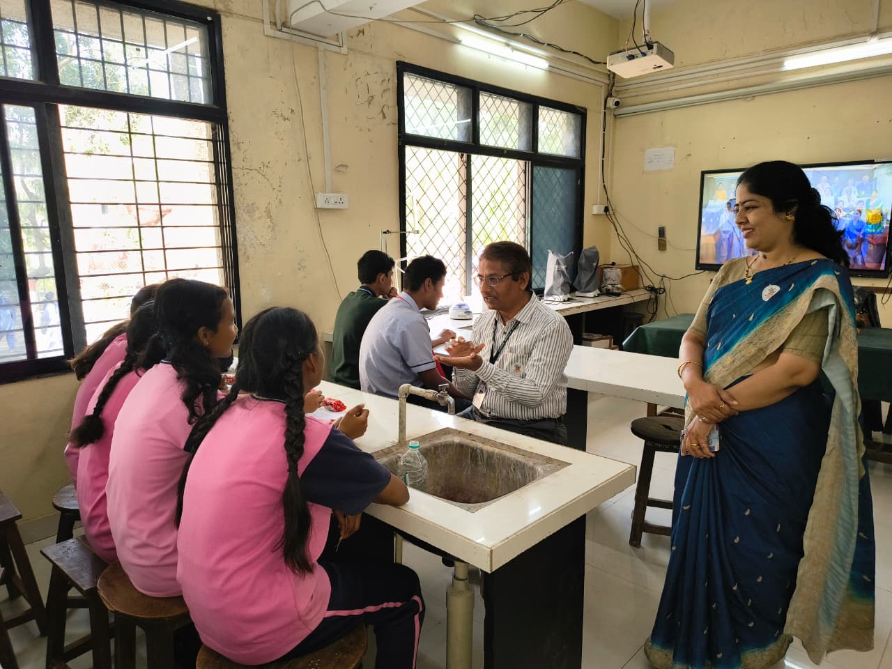 school students discuss with teacher staff