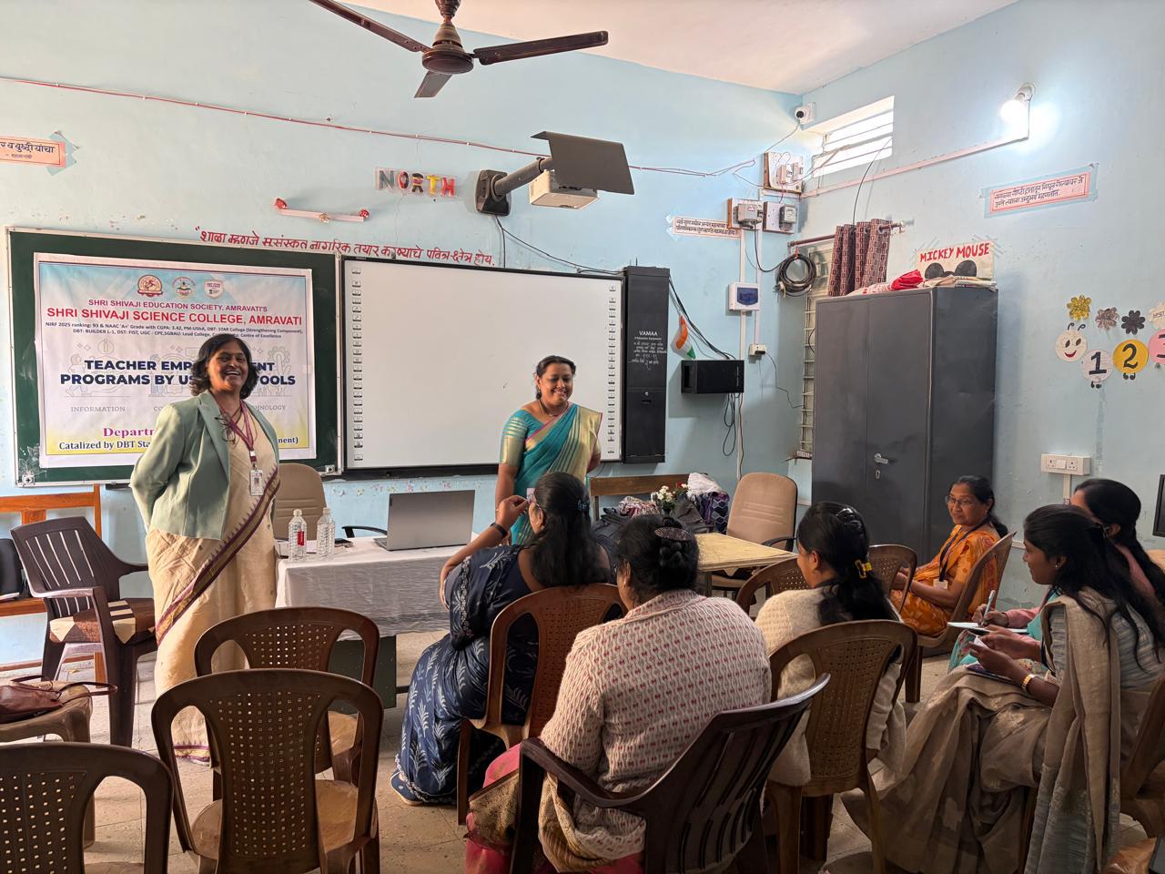 “Teachers enhancing digital skills through ICT-based training session.”