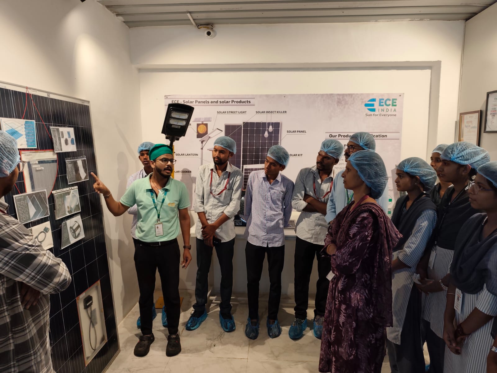 Technician from ECE solar panel industry explaining   the process of assembling of solar panel