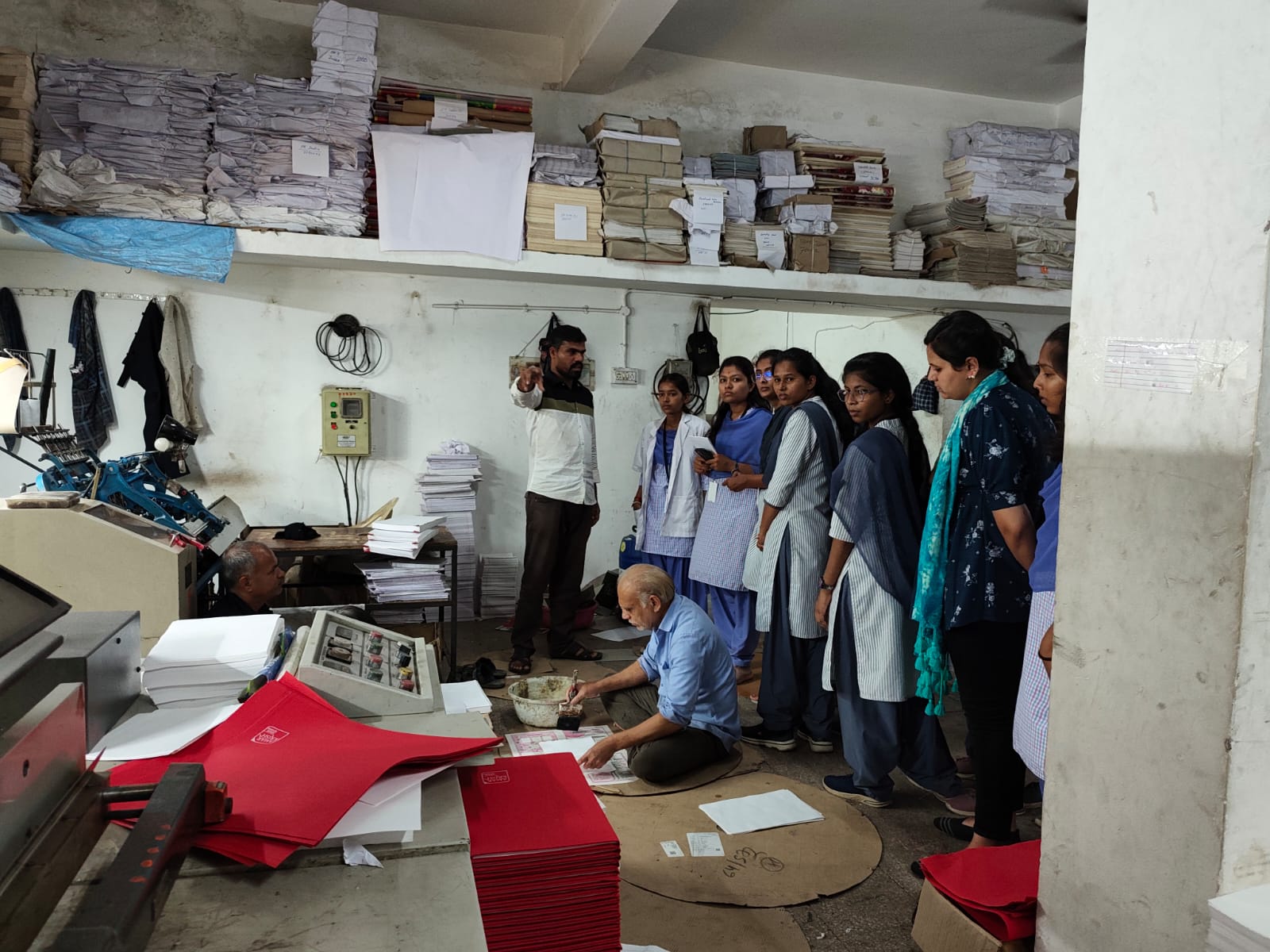 Technician Explaining the process of formation of different  products from plain paper 