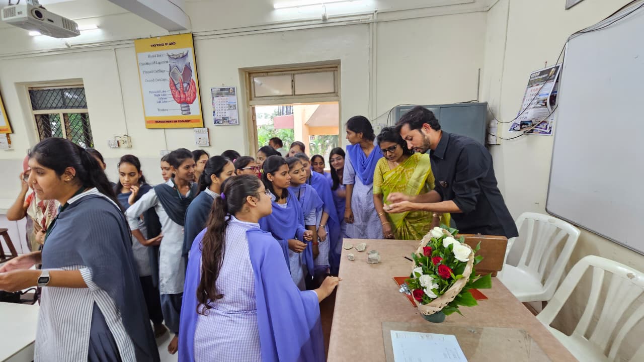Mr. Keole showing different types of rocks collected during his work to students