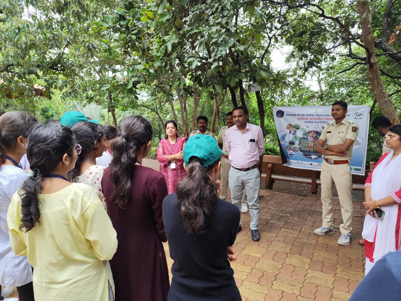 Forest guards explaining the significance of "indirect evidence" such as animal tracks (pugmarks) and scat. 