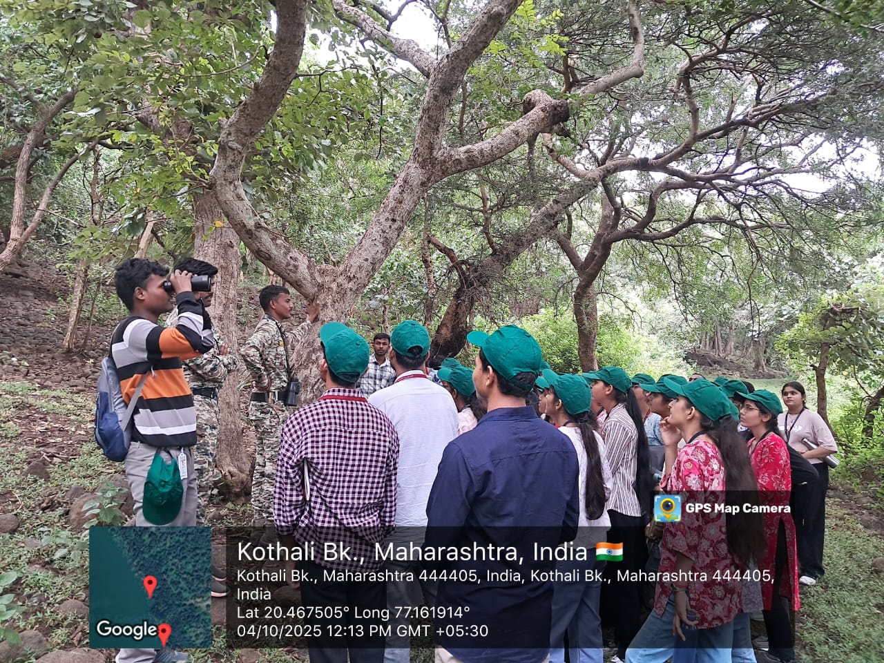 Students using binoculars to observe bird species and canopy structure under the guidance of forest officials.
